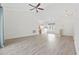 Spacious living room with wood floors, fan, and an open layout leading to the dining and kitchen area at 50 Turning Stone Blvd. # 7, Murrells Inlet, SC 29576