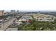 An aerial view pinpoints a property nestled among greenery, with nearby shops and commercial areas, close to city amenities at 505 28Th Ave. N, Myrtle Beach, SC 29577