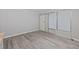 A neutral living room features wood-look floors, white door and window, and outlets at 505 28Th Ave. N, Myrtle Beach, SC 29577