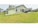 Spacious backyard featuring a well-maintained lawn, convenient storage shed, and comfortable patio setup at 5059 Sundrop Ln., Little River, SC 29566