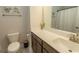 Bathroom featuring a toilet, sink with dark wood cabinets and coastal-themed decor at 5059 Sundrop Ln., Little River, SC 29566