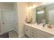 Bright bathroom featuring a double sink vanity with white countertops and modern fixtures at 5059 Sundrop Ln., Little River, SC 29566