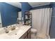 Bathroom with a vanity, mirror, and white shower curtain; a clean and functional space at 5059 Sundrop Ln., Little River, SC 29566
