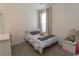 Cozy bedroom featuring a comfortable bed, neutral decor and a sunlit window at 5059 Sundrop Ln., Little River, SC 29566