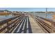 Scenic boardwalk overlooking a serene lake with a fountain feature, perfect for leisurely strolls at 5059 Sundrop Ln., Little River, SC 29566