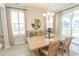 Bright dining room with a wood table set for four, complemented by stylish decor and natural light at 5059 Sundrop Ln., Little River, SC 29566