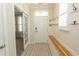 Bright entryway with hardwood floors, convenient coat hooks, and a stylish bench for added comfort at 5059 Sundrop Ln., Little River, SC 29566