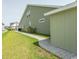 Side exterior showcasing a lush green lawn, convenient storage shed, and beautifully landscaped walkway at 5059 Sundrop Ln., Little River, SC 29566