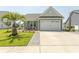 Inviting home exterior showcasing a two-car garage, well-kept lawn, and neatly landscaped yard at 5059 Sundrop Ln., Little River, SC 29566