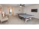 Spacious game room featuring a ping pong table, comfortable seating, and a ceiling fan at 5059 Sundrop Ln., Little River, SC 29566