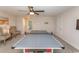 Well-lit game room with ping pong table, comfortable seating, and a view of the entryway at 5059 Sundrop Ln., Little River, SC 29566