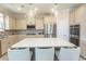 Modern kitchen with stainless steel appliances, island with seating, and stylish lighting fixtures at 5059 Sundrop Ln., Little River, SC 29566