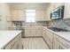 Bright kitchen with neutral cabinets, modern appliances, and tile backsplash; a chef's dream at 5059 Sundrop Ln., Little River, SC 29566