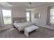 Spacious main bedroom features tray ceiling, large windows, and neutral tones; a serene retreat at 5059 Sundrop Ln., Little River, SC 29566