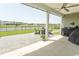Covered patio with scenic views of the lake, complete with outdoor seating and a grill at 5059 Sundrop Ln., Little River, SC 29566