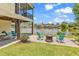 Waterfront backyard featuring a patio with Adirondack chairs, a fire pit, and stunning views of the tranquil lake at 521 Bay Drive Ext., Garden City Beach, SC 29576