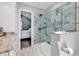 Bathroom featuring a glass shower with marble tile, with a glimpse into the adjoining bedroom at 521 Bay Drive Ext., Garden City Beach, SC 29576