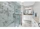 Modern bathroom with a glass shower, marble tile, granite countertop, and dual vanity sinks at 521 Bay Drive Ext., Garden City Beach, SC 29576