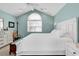 Light-filled bedroom featuring a cozy layout, vaulted ceilings, and a large window for ample natural light at 521 Bay Drive Ext., Garden City Beach, SC 29576