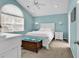 Bright bedroom featuring a white bed frame, vaulted ceiling, and a large window letting in natural light at 521 Bay Drive Ext., Garden City Beach, SC 29576