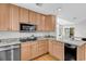Well-lit kitchen featuring wood cabinets, granite countertops, stainless steel appliances, and hardwood floors at 521 Bay Drive Ext., Garden City Beach, SC 29576