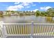 Stunning lake view from a deck with a white railing, capturing the serene waterfront community at 521 Bay Drive Ext., Garden City Beach, SC 29576