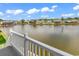 Lake view from deck overlooking waterfront homes and fountain on a sunny day at 521 Bay Drive Ext., Garden City Beach, SC 29576