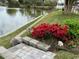 Beautifully landscaped yard with flowers, retaining wall and serene lake view at 521 Bay Drive Ext., Garden City Beach, SC 29576