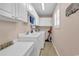 Functional laundry room with ample cabinet space, a utility sink, and a side-by-side washer and dryer at 521 Bay Drive Ext., Garden City Beach, SC 29576