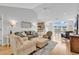 Bright and airy living room boasts hardwood floors, neutral walls, and seamless access to the kitchen and dining area at 521 Bay Drive Ext., Garden City Beach, SC 29576