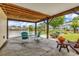 Charming covered patio overlooking a serene lake, perfect for outdoor relaxation and entertaining guests at 521 Bay Drive Ext., Garden City Beach, SC 29576