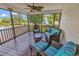 Cozy screened porch with comfortable seating offers beautiful lake views at 521 Bay Drive Ext., Garden City Beach, SC 29576