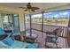 Relaxing screened porch with wicker furniture overlooking tranquil lake views at 521 Bay Drive Ext., Garden City Beach, SC 29576