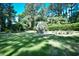 Expansive backyard with lush green lawn, mature trees, and cozy outdoor seating area perfect for relaxing at 5718 Herring Gull Circle, North Myrtle Beach, SC 29582