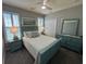 Well-lit bedroom with shutters and a fan at 5718 Herring Gull Circle, North Myrtle Beach, SC 29582