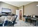 Workout room featuring a treadmill, exercise bike, desk, and doorway to an adjacent room at 5718 Herring Gull Circle, North Myrtle Beach, SC 29582