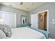 Relaxing bedroom with a light blue dresser, ceiling fan, and access to another room at 5718 Herring Gull Circle, North Myrtle Beach, SC 29582