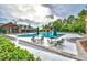 Resort-style community pool with lounge chairs, tables and lush landscaping surrounding the deck at 5718 Herring Gull Circle, North Myrtle Beach, SC 29582