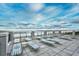 Relaxing deck overlooking the ocean with lounge chairs and tables at 5718 Herring Gull Circle, North Myrtle Beach, SC 29582