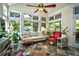 Bright sunroom with tile floors, many windows, ceiling fan, and comfortable seating at 5718 Herring Gull Circle, North Myrtle Beach, SC 29582