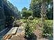 Picturesque landscaping and plantings surround the screened patio with tropical palm trees and flowering bushes at 5718 Herring Gull Circle, North Myrtle Beach, SC 29582