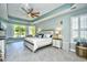 A serene main bedroom features neutral decor, tray ceilings, and a bay window with shuttered windows at 5718 Herring Gull Circle, North Myrtle Beach, SC 29582