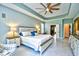 Spacious main bedroom with tray ceilings, tiled floors, walk-in closet, and a seating area at 5718 Herring Gull Circle, North Myrtle Beach, SC 29582