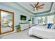 Bright main bedroom with tray ceilings, tiled floors, full-length mirror, and a bay window at 5718 Herring Gull Circle, North Myrtle Beach, SC 29582