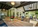 Covered outdoor dining area with a long table, ceiling fans, and comfortable lounge seating at 5718 Herring Gull Circle, North Myrtle Beach, SC 29582
