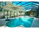 Large screened-in pool area with dining, kitchen, seating, and lush tropical foliage views at 5718 Herring Gull Circle, North Myrtle Beach, SC 29582