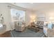 Cozy living room with large window, neutral decor, comfortable seating, and stylish accents at 585 Strawberry Field Way, Galivants Ferry, SC 29544
