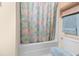 Neutral bathroom with a shower over bath and matching towels at 613 S 2Nd Ave. # 21D, North Myrtle Beach, SC 29582