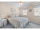 Relaxing bedroom featuring soft bedding, a ceiling fan, and multiple windows at 613 S 2Nd Ave. # 21D, North Myrtle Beach, SC 29582