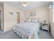 Bright bedroom featuring a double bed with floral bedding and a ceiling fan at 613 S 2Nd Ave. # 21D, North Myrtle Beach, SC 29582